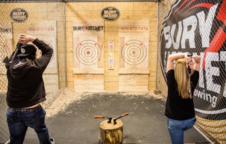 a couple of people that are standing in front of a fence