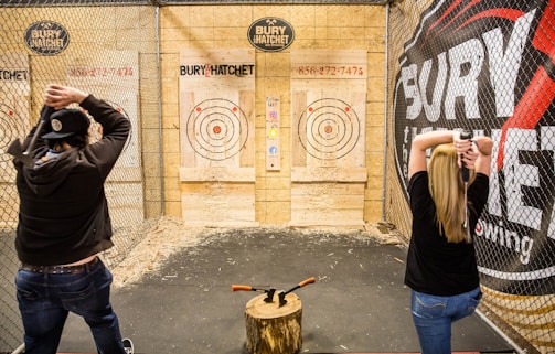 a couple of people that are standing in front of a fence