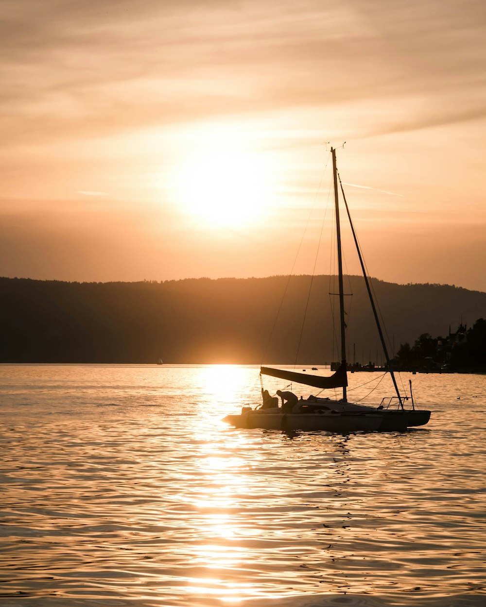 silhouette photography of boat on body of water