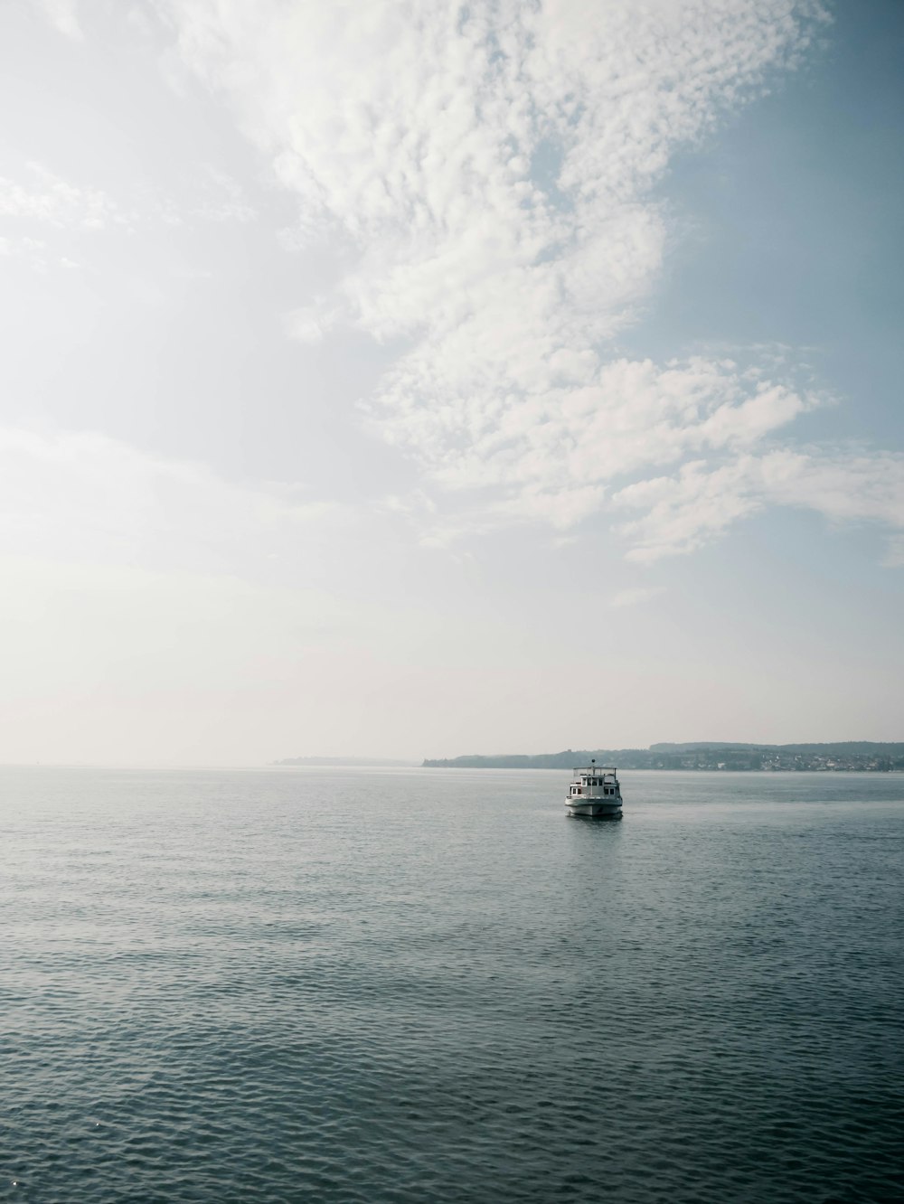 white sailboat in the middle of ocean