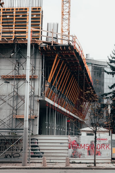 Photo of a construction site near Pavia showing workers collaborating on a building project.