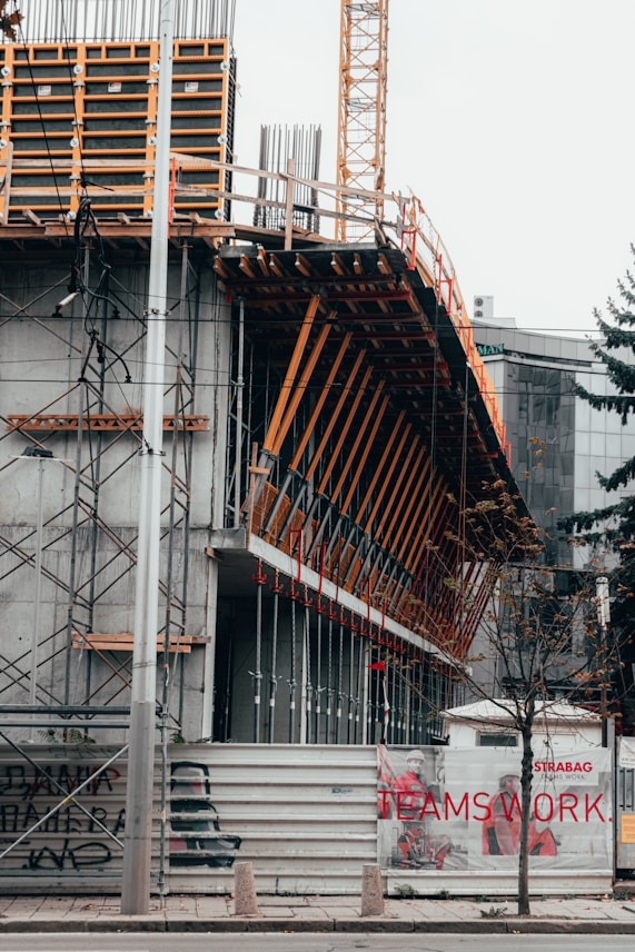 Photo of a construction site near Pavia showing workers collaborating on a building project.