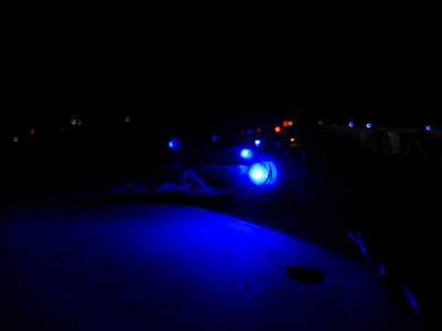 A sleek blue and silver AWP skin glowing under neon lights.