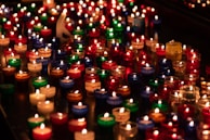 A vibrant arrangement of candles in various colors and shapes.