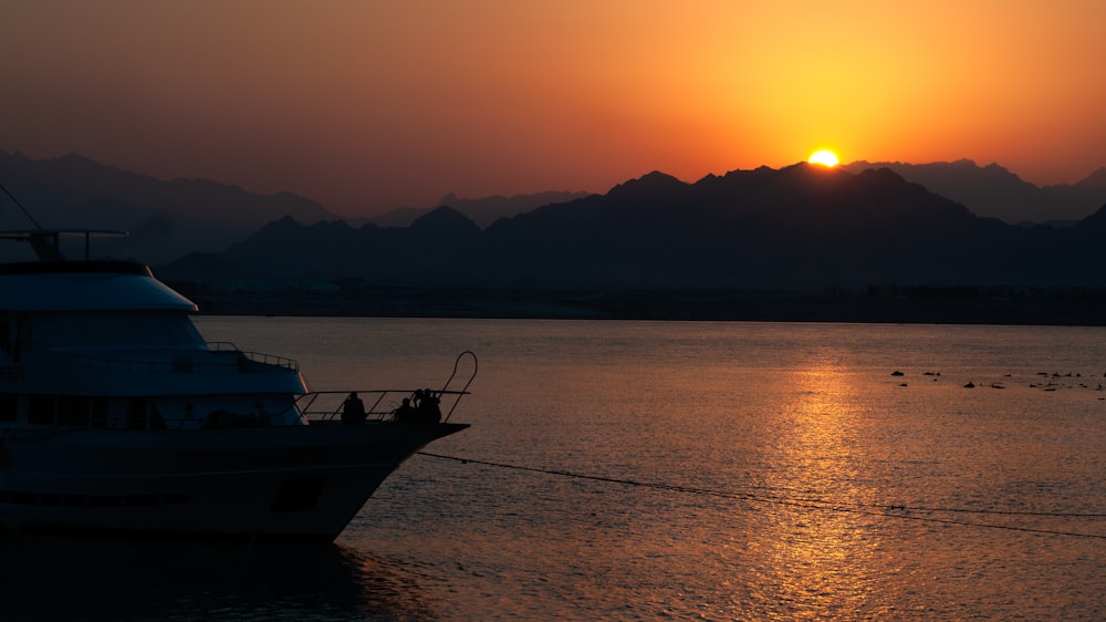 a boat in a body of water at sunset