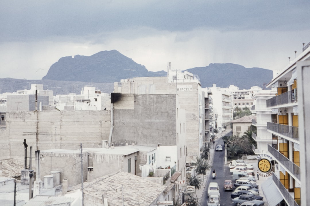 gray and white concrete buildings under gray clouds