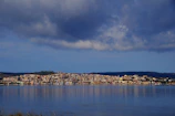 A panoramic view of a coastal town with colorful buildings and the sea in the background