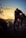 A cyclist riding on a scenic mountain trail during sunset.