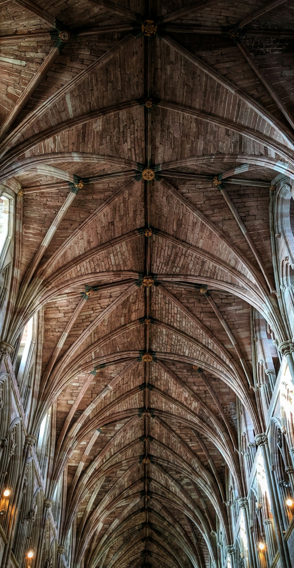 low-angle photogra[hy of brown wooden cathedral roof