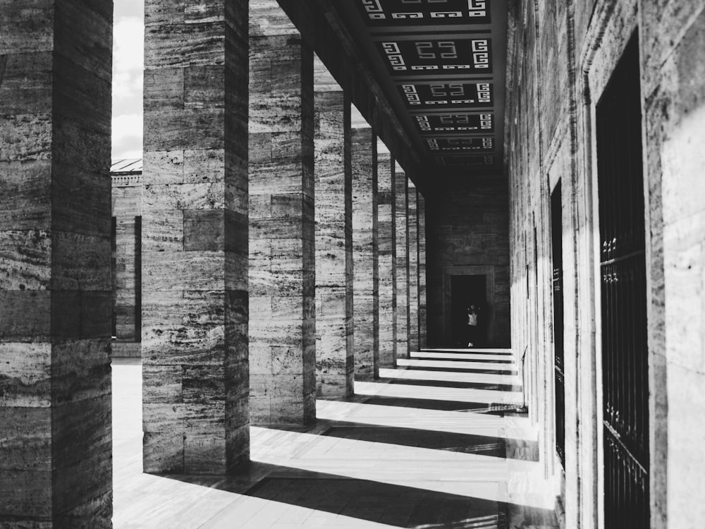 a black and white photo of a long hallway