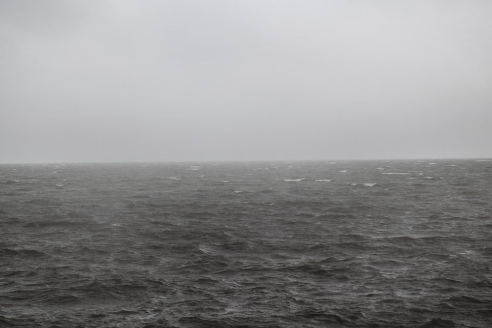 grayscale photo of waves on sea