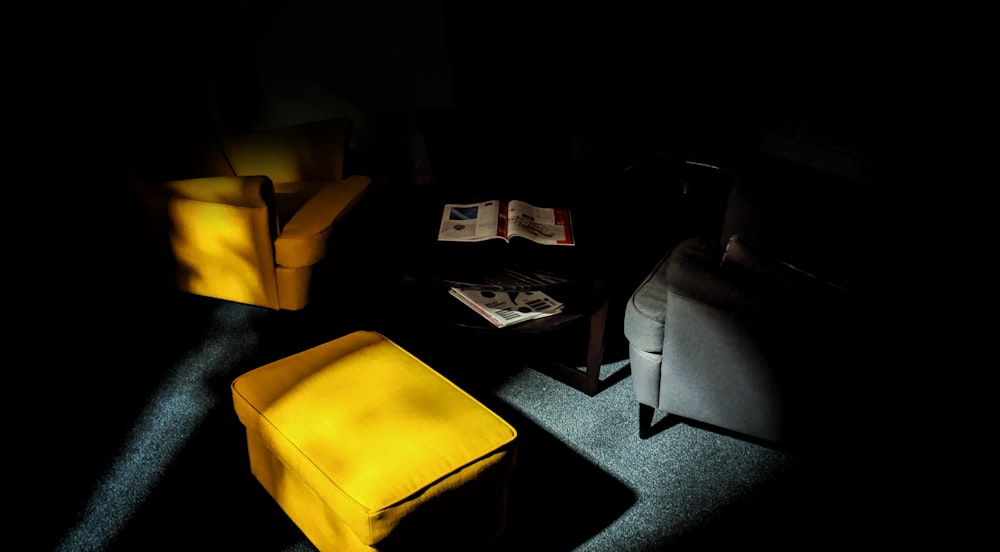 yellow ottoman inside dark room