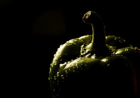 close-up photography of dew on green bell pepper