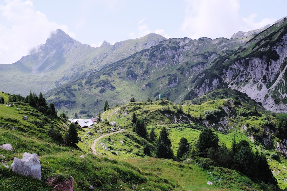 green-and-brown mountains under white clouds