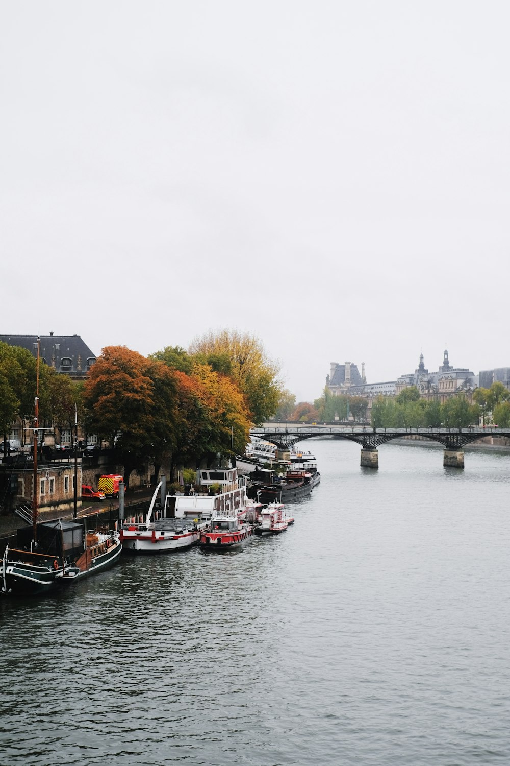 boats near gray concrete bridge during daytime