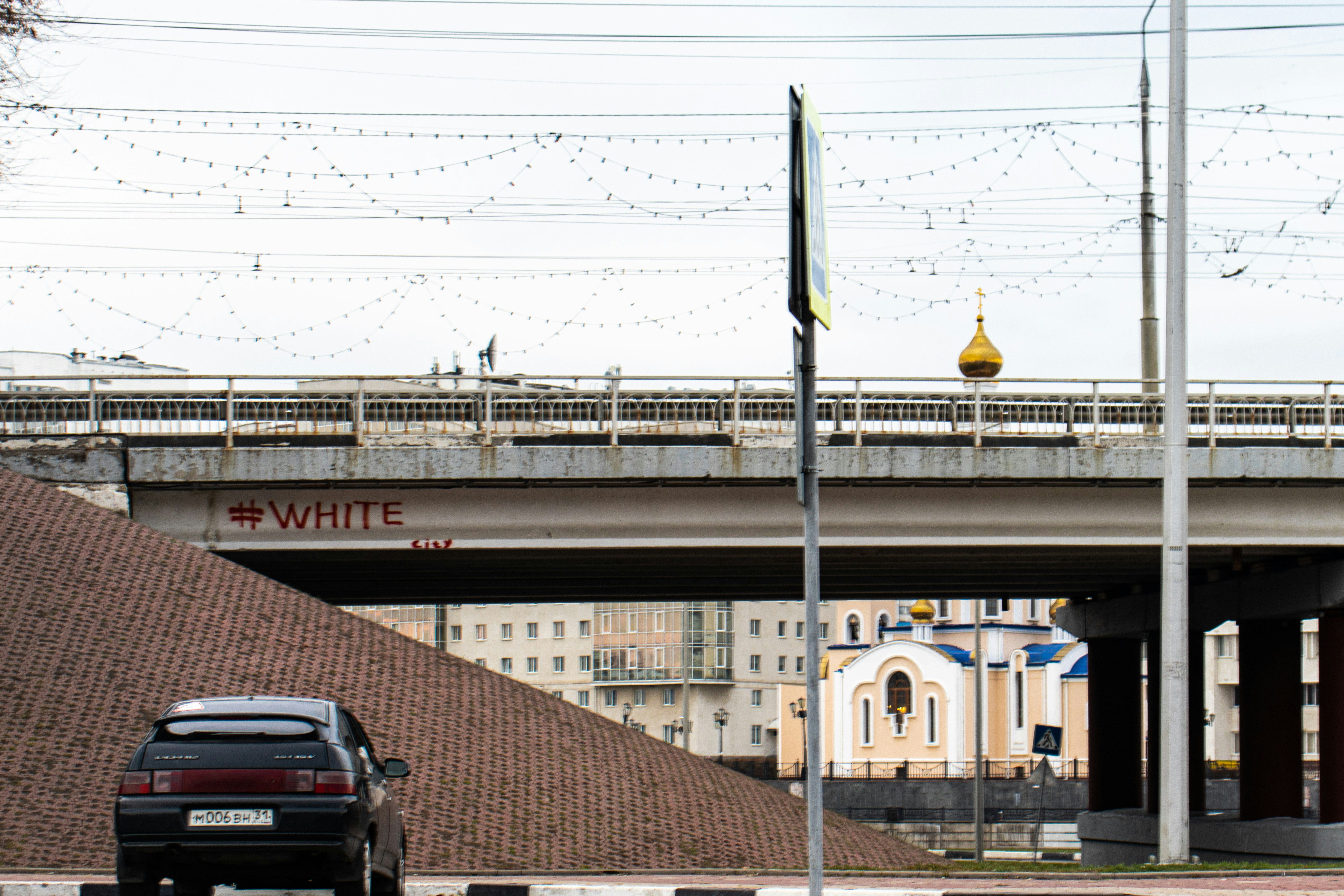 black car parked front of bridge