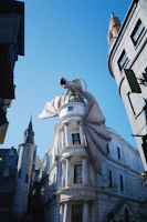 An open fantasy novel with an illustrated dragon soaring above a medieval castle.