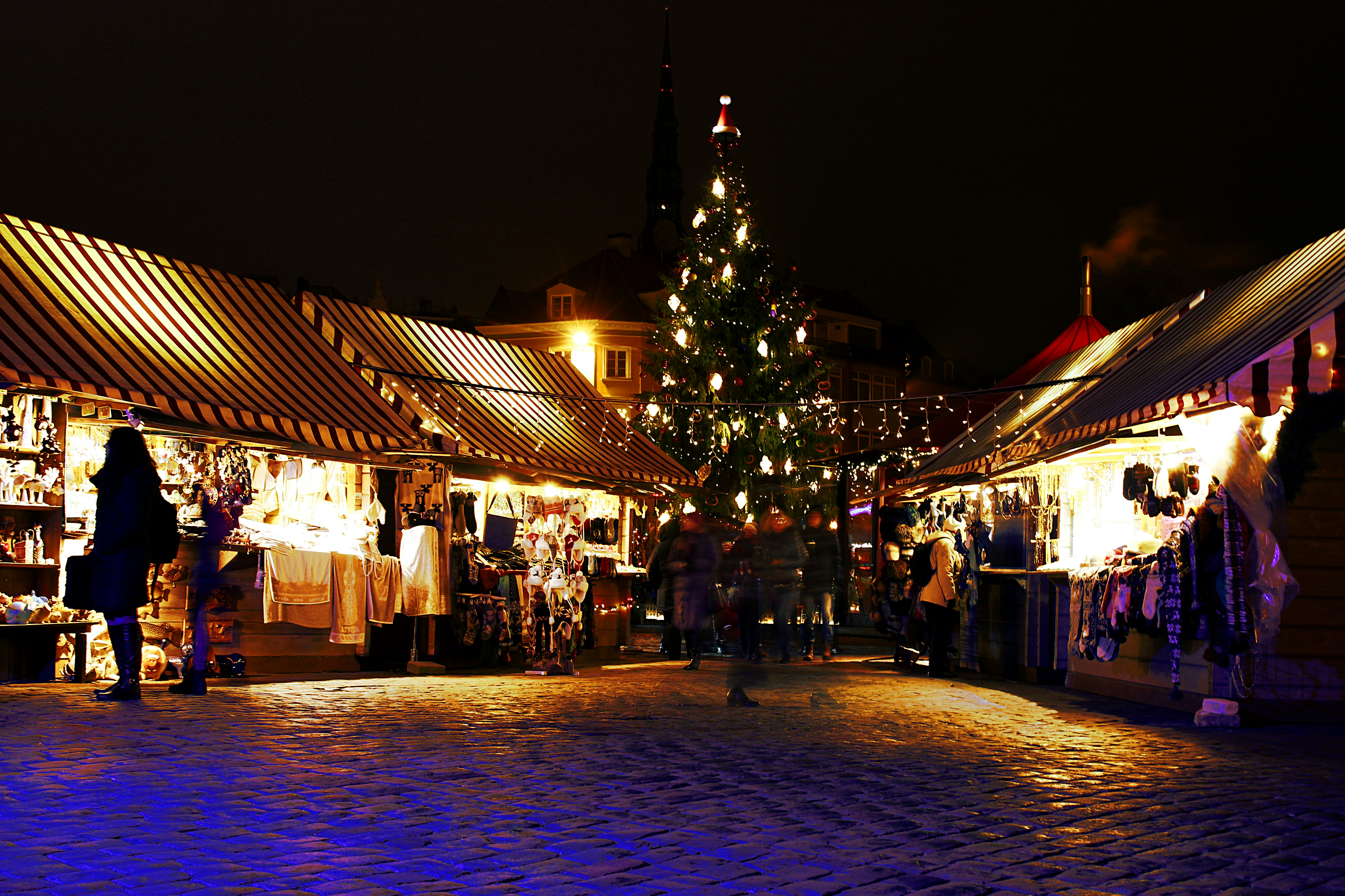 lighted Christmas tree surrounded by houses, Christmas market in Riga, Latvia.