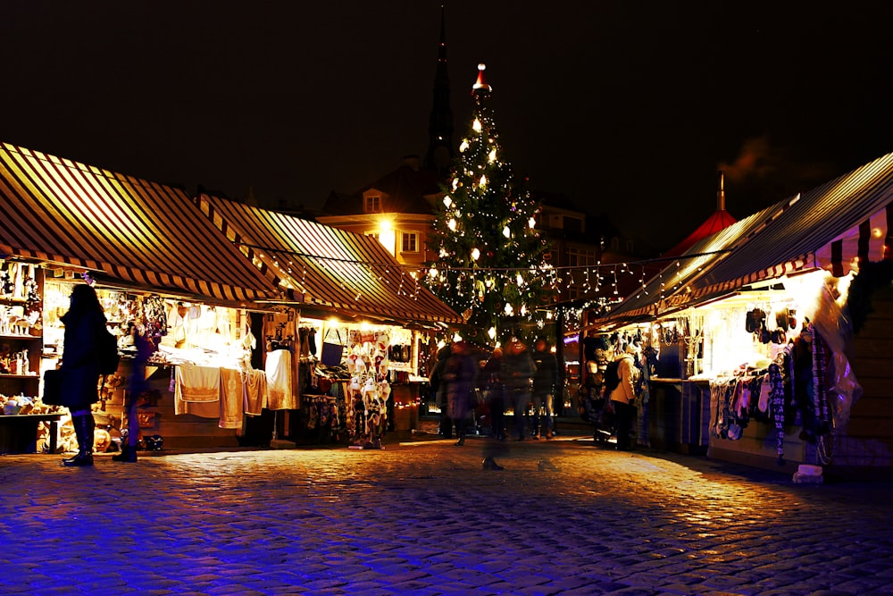 lighted Christmas tree surrounded by houses