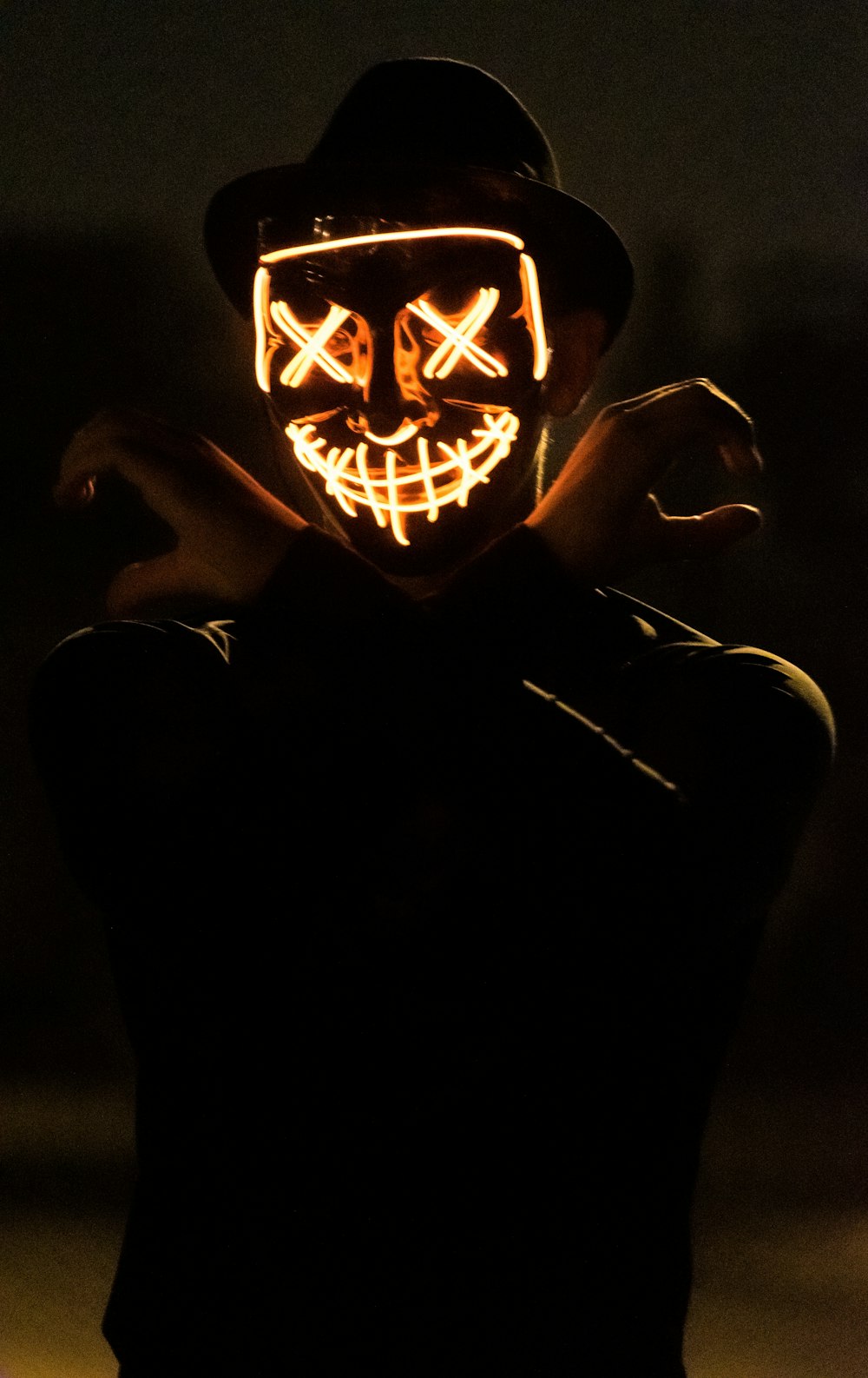 man wearing hat with X-eyes mask