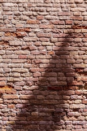Rustic brick wall detail showcasing rich red and brown hues.
