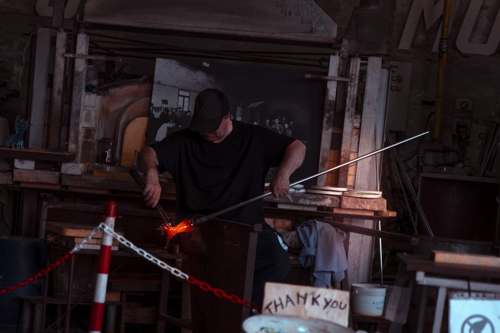 man holding gray metal rod