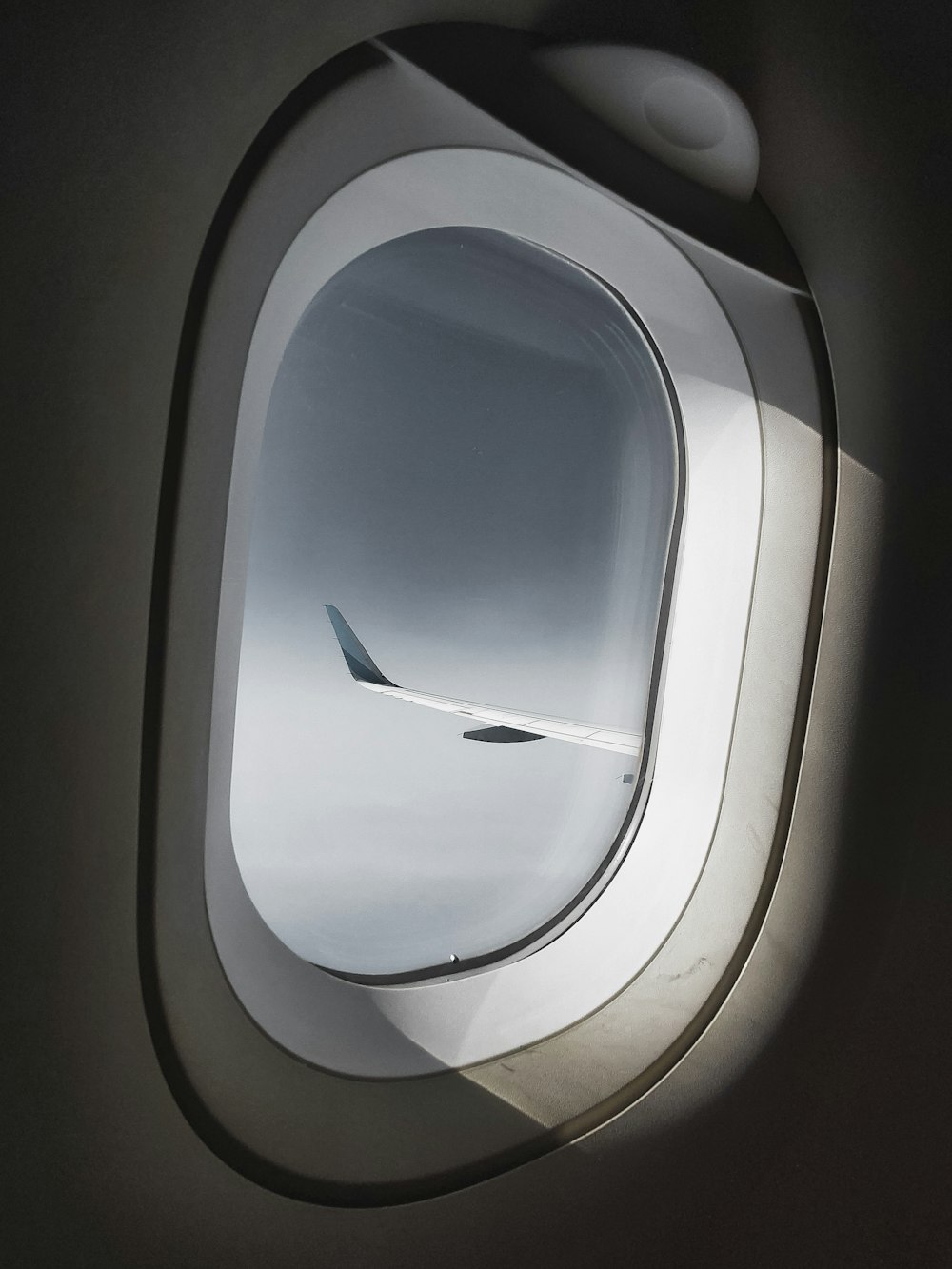 architectural photography of white aircraft window