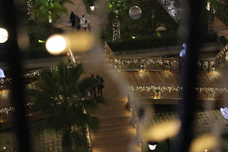 Decorative solar garden lights casting a warm glow in a public park.