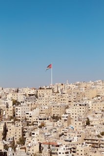 brown houses with red and blue flag waving on pole