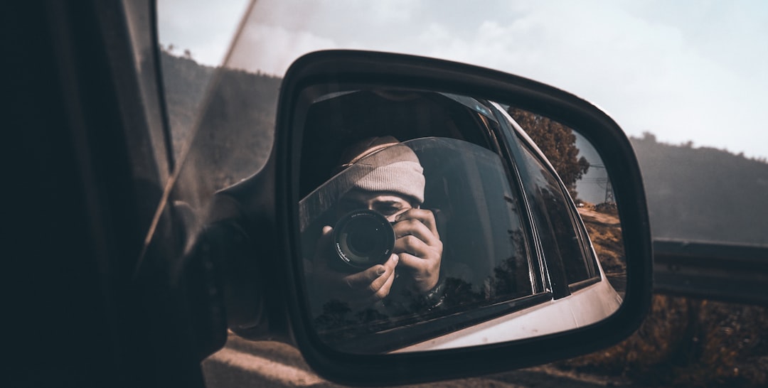 Person using their smartphone to photograph vehicle damage - Car accident injury lawyer