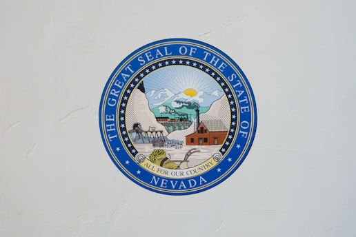 The Great Seal of the State of Nevada logo on white wall
