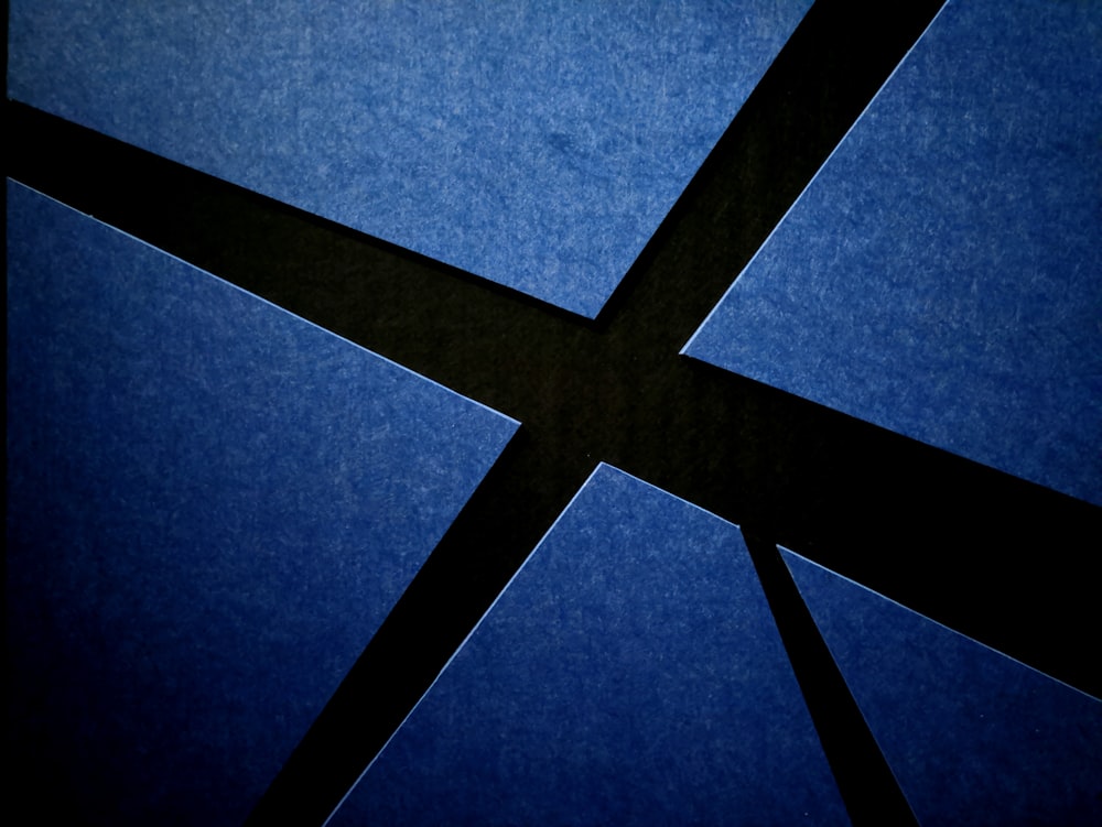 a blue wall with a black cross on it