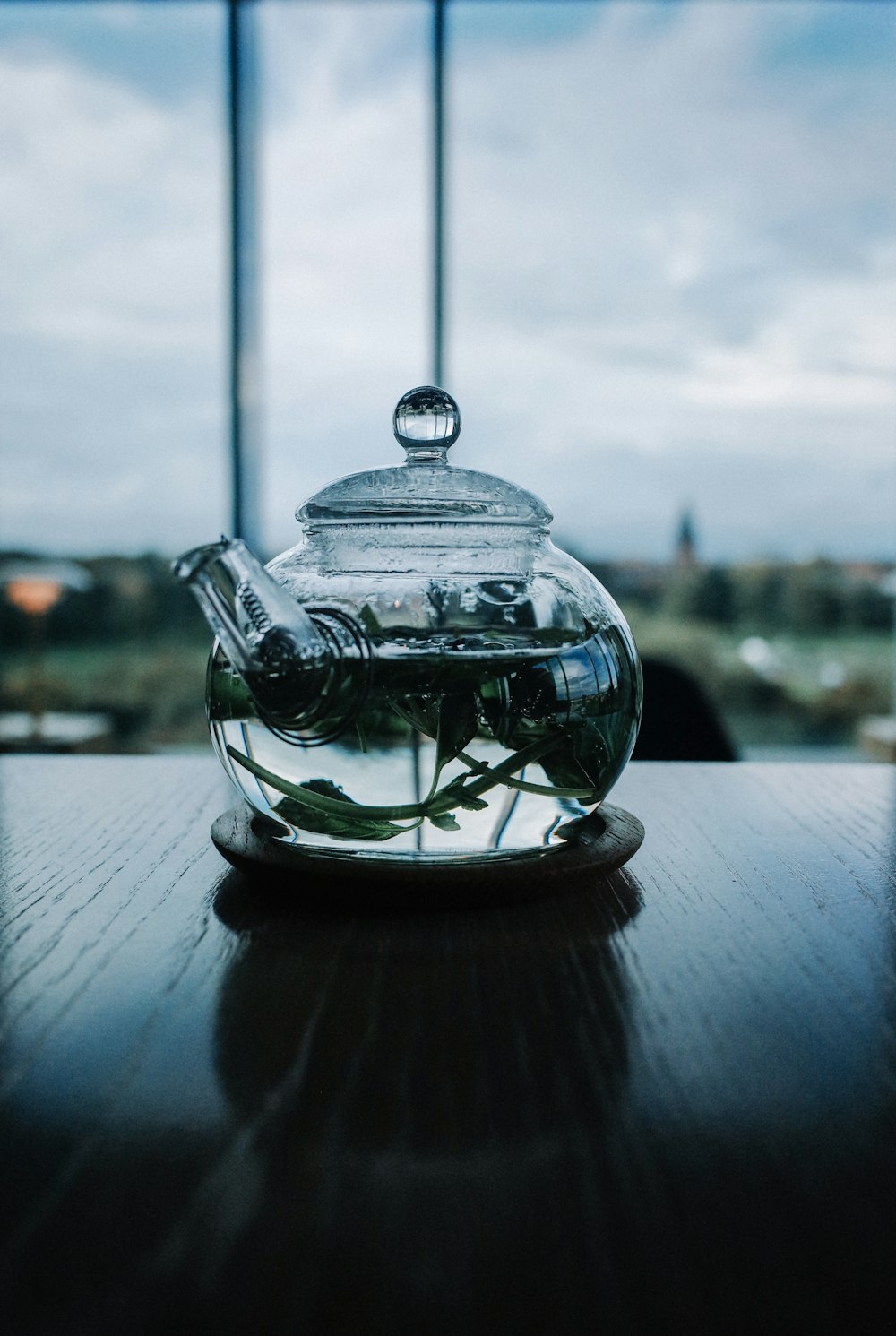 clear glass teapot on table