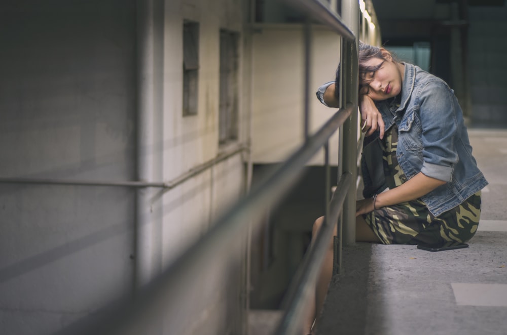 woman leaning on metal railing