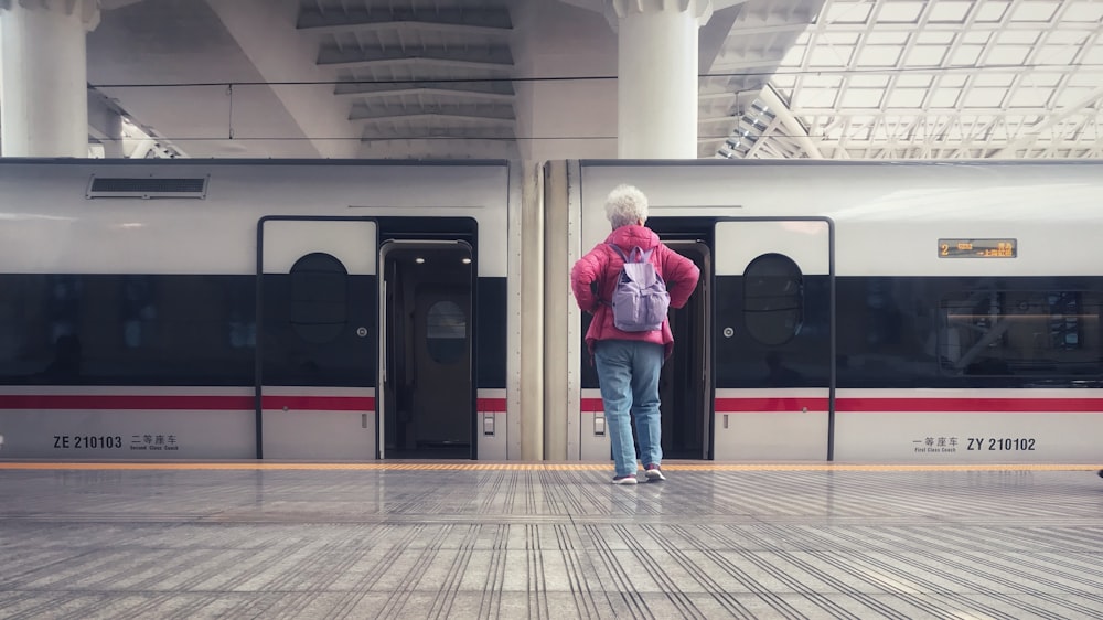 person standing beside train