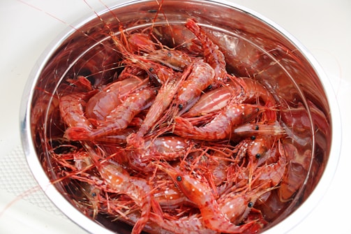 Bright orange fresh shrimp piled in a rustic basket.