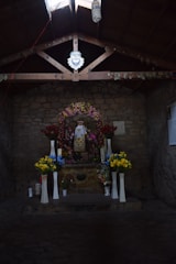 A serene chapel interior with soft lighting and floral arrangements.