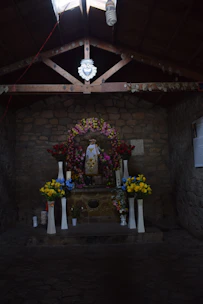 A beautifully decorated wedding altar with pink and white floral arrangements under soft natural light.