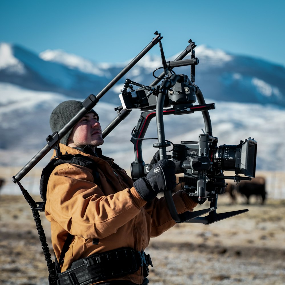 man carrying camera