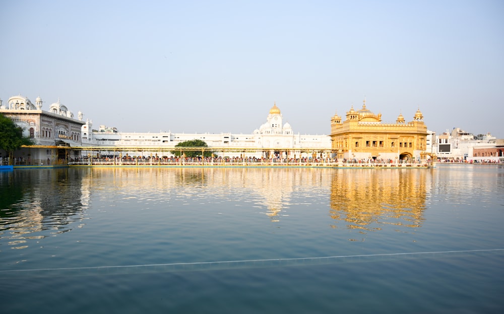 white and gold building near body of water