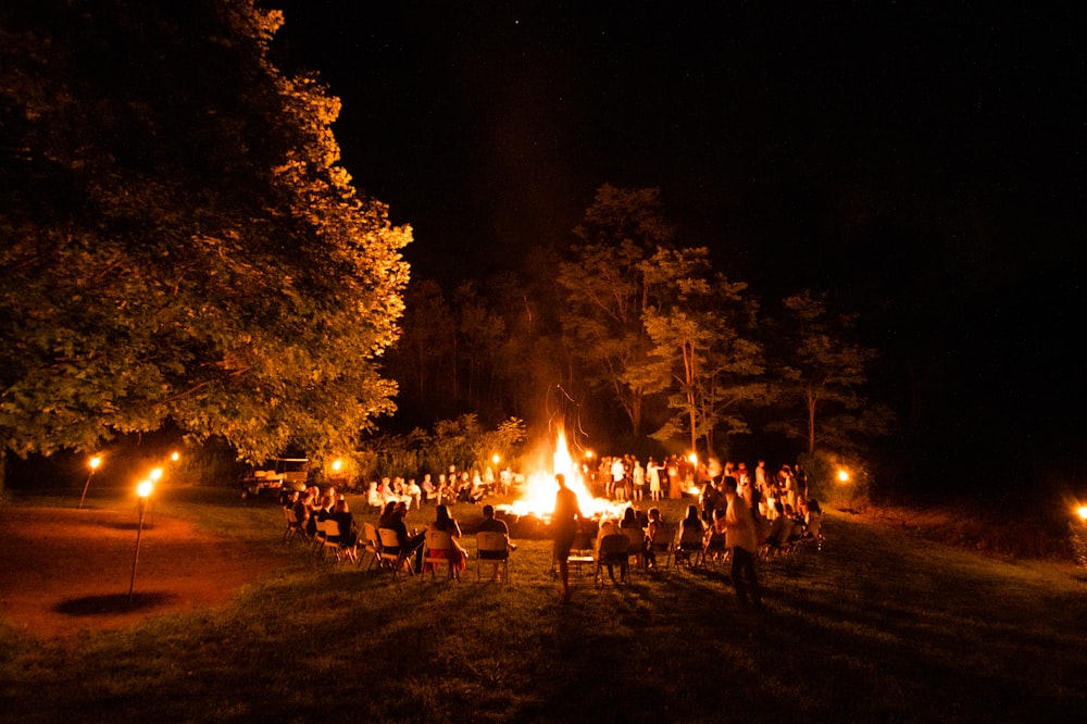 people sitting around bonfire