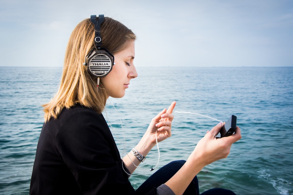 woman wearing black headphones