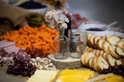 An elegant charcuterie board with organic cheeses, nuts, and edible flowers arranged with care.