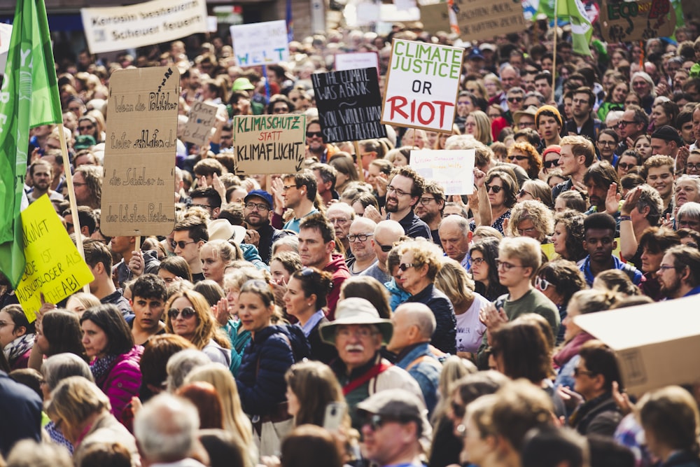 people gathering holding signages