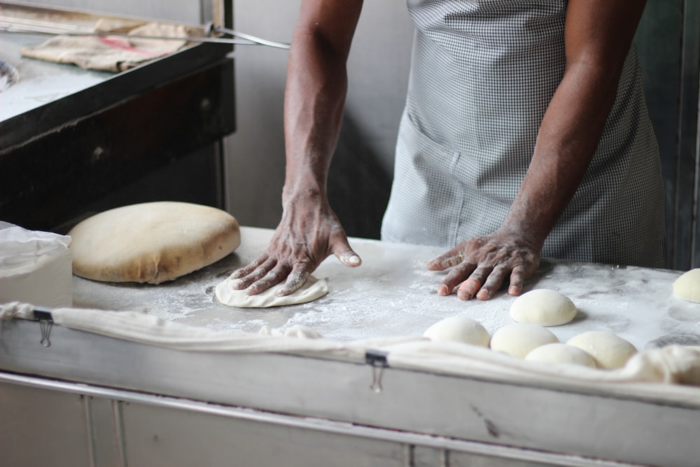 person standing while making dough