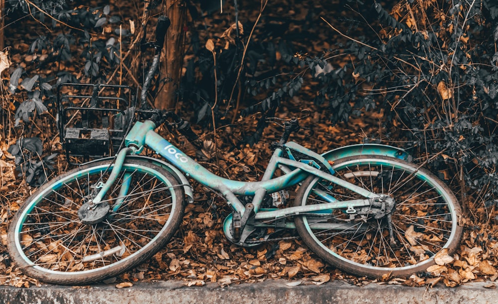 green bike on ground near plants