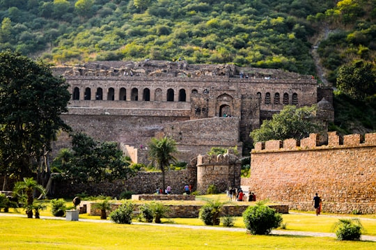 architectural photography of gray concrete monument in Bhangarh Fort India