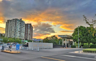 Wide shot of a beautiful gated community entrance at sunset.