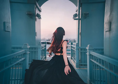 A mysterious woman in a silk robe walking along the Seine river at twilight.