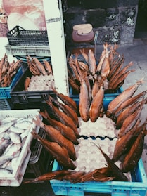 A rustic wooden table displaying an assortment of smoked fish and seafood products.